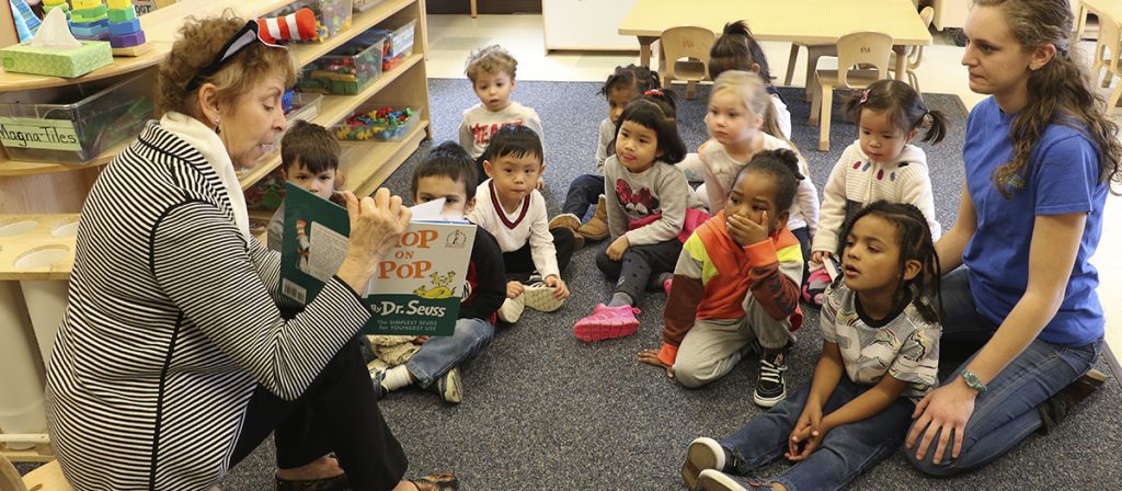 Teacher reads book to class at the Early Learning Center