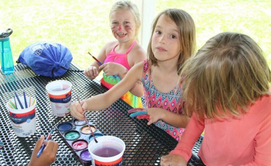 Three students painting at the Early Learning Center