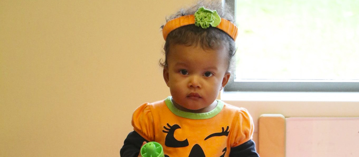 Toddler in a pumpkin costume