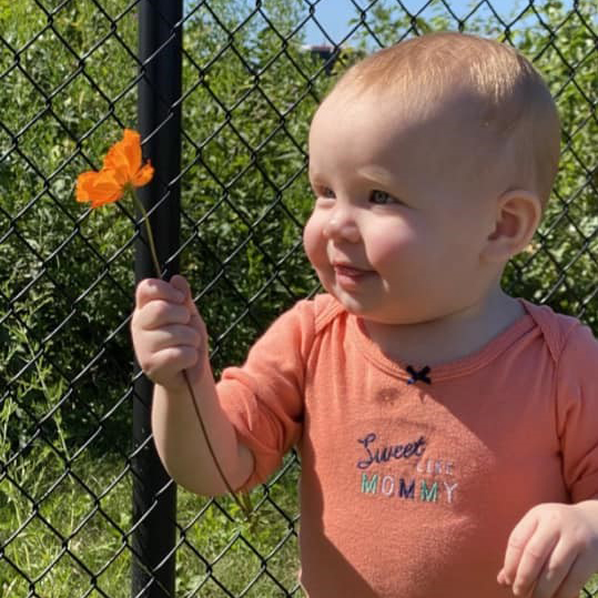 Infant girl with flower